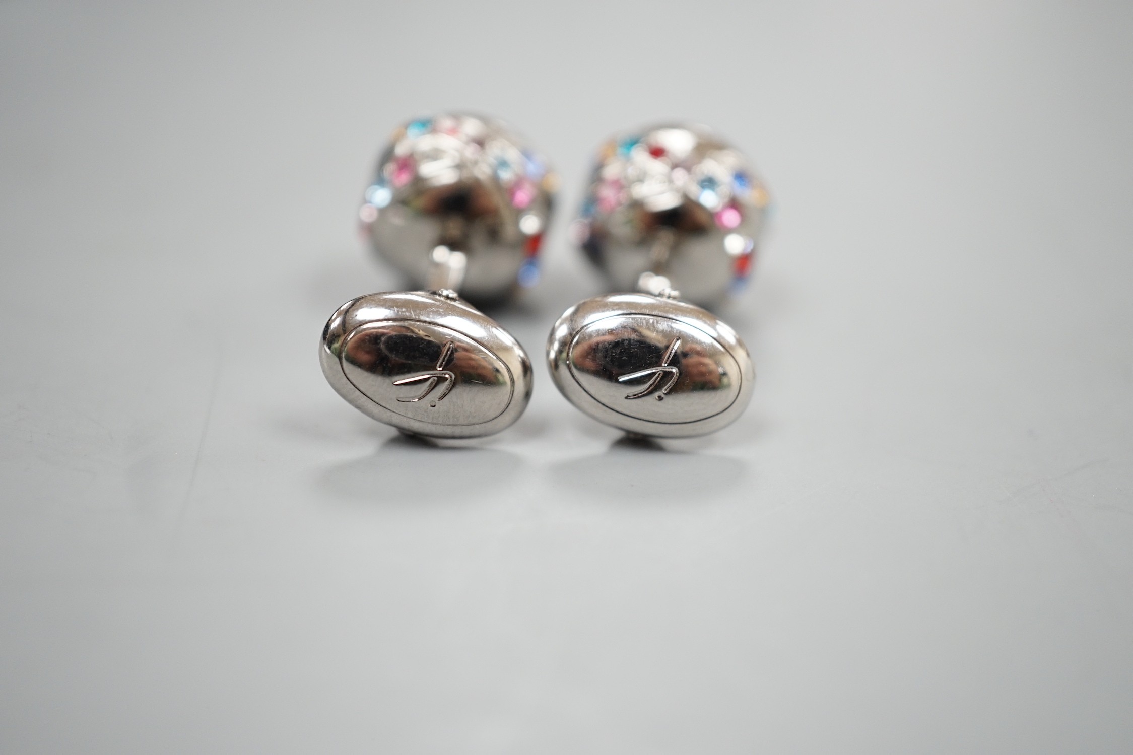 A modern pair of metal and coloured paste set cufflinks.